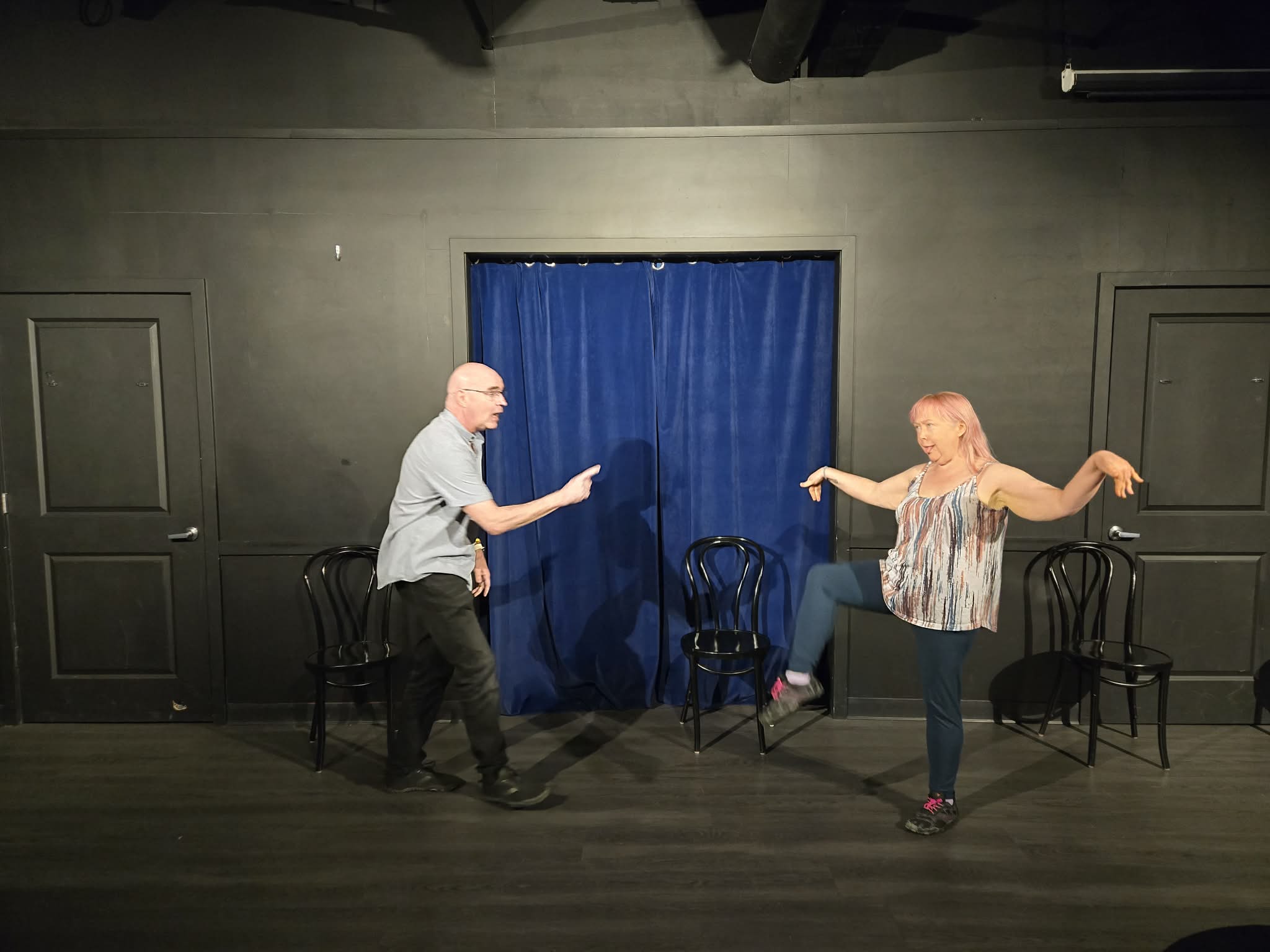 Daniel and Chan performing an improv scene on stage